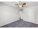 Well-lit bedroom with plush carpeting, ceiling fan, and neutral paint at 1618 Chancery Ln, Lithia Springs, GA 30122