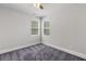 Bright, carpeted bedroom with ample natural light from two windows at 1618 Chancery Ln, Lithia Springs, GA 30122