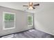 Bright bedroom with two large windows and a ceiling fan at 1618 Chancery Ln, Lithia Springs, GA 30122