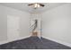 Cozy bedroom with a ceiling fan and open doorway to the staircase at 1618 Chancery Ln, Lithia Springs, GA 30122