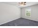 Carpeted bedroom featuring a ceiling fan and natural light from the window at 1618 Chancery Ln, Lithia Springs, GA 30122