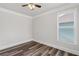 Cozy bedroom with natural light, ceiling fan, and wood-look flooring at 1618 Chancery Ln, Lithia Springs, GA 30122