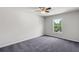 Carpeted bedroom with large window offering views of mature trees at 1618 Chancery Ln, Lithia Springs, GA 30122