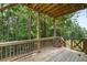 Wooden deck surrounded by lush greenery and wooded area at 1618 Chancery Ln, Lithia Springs, GA 30122