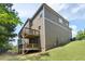 Rear view of house with two decks and sloped yard with green grass at 1618 Chancery Ln, Lithia Springs, GA 30122