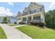 Street view of a lovely two-story home with a cozy front porch and a green lawn at 1618 Chancery Ln, Lithia Springs, GA 30122