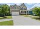 Beautiful front view of a two-story home featuring a large driveway and manicured lawn at 1618 Chancery Ln, Lithia Springs, GA 30122