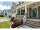 Close-up of a charming front porch with white railings and a blue front door at 1618 Chancery Ln, Lithia Springs, GA 30122