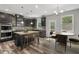 Well-designed kitchen featuring a granite island, stainless appliances, and adjacent dining area at 1618 Chancery Ln, Lithia Springs, GA 30122