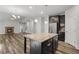 Gourmet kitchen featuring a center island, granite counters, stainless steel appliances, and a stone fireplace at 1618 Chancery Ln, Lithia Springs, GA 30122