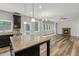 Open kitchen featuring granite countertops, stainless steel appliances, and hardwood floors at 1618 Chancery Ln, Lithia Springs, GA 30122