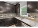 Kitchen featuring granite countertops, dark wood cabinets, and stainless steel appliances at 1618 Chancery Ln, Lithia Springs, GA 30122