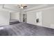 Large living room with plush gray carpeting, and an open floor plan at 1618 Chancery Ln, Lithia Springs, GA 30122