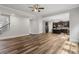 Open living room area with hardwood floors, an adjacent kitchen, and a staircase at 1618 Chancery Ln, Lithia Springs, GA 30122