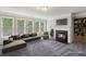 Cozy living room featuring a fireplace, large windows, and plush seating, perfect for unwinding after a long day at 1618 Chancery Ln, Lithia Springs, GA 30122