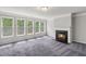 Living room with a fireplace and large windows offering natural light at 1618 Chancery Ln, Lithia Springs, GA 30122