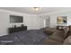 Comfortable living room with plush seating, a modern entertainment center, and soft carpeting, great for relaxation at 1618 Chancery Ln, Lithia Springs, GA 30122