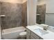 Bathroom with white vanity, gray tile backsplash and shower/tub combination at 4234 Freight St, Tucker, GA 30084