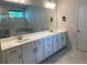 Bathroom featuring double sinks, a large mirror, and modern finishes at 4234 Freight St, Tucker, GA 30084