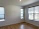 Bright bedroom with hardwood floors and three large windows letting in ample natural light at 4234 Freight St, Tucker, GA 30084