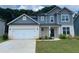Charming two-story home with a gray roof, white brick, and a two-car garage at 4234 Freight St, Tucker, GA 30084