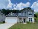 Charming two-story home with a gray roof, white brick, and a two-car garage at 4234 Freight St, Tucker, GA 30084