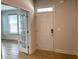 Bright foyer with hardwood floors, a white front door, and an open doorway leading to another room at 4234 Freight St, Tucker, GA 30084