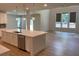 Open-concept kitchen with island, stainless appliances, and view of the living room with fireplace at 4234 Freight St, Tucker, GA 30084