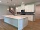 Bright kitchen featuring white cabinets, quartz countertops, and modern pendant lighting at 4234 Freight St, Tucker, GA 30084