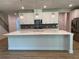 Bright, open kitchen with a large island, modern appliances, and stylish pendant lights at 4234 Freight St, Tucker, GA 30084