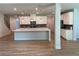 Bright kitchen with white cabinets, an island with a sink, and stainless steel appliances at 4234 Freight St, Tucker, GA 30084