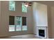 Bright living room with fireplace, high ceilings, large windows, and modern ceiling fan at 4234 Freight St, Tucker, GA 30084
