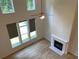 Bright living room featuring a fireplace, ceiling fan, and multiple windows with backyard views at 4234 Freight St, Tucker, GA 30084