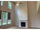 Cozy living room with fireplace, large windows providing natural light, and tall ceilings at 4234 Freight St, Tucker, GA 30084