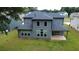 A modern house featuring a covered patio and large windows overlooking the backyard at 4234 Freight St, Tucker, GA 30084