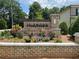 Idelwood Estates sign surrounded by colorful flowers and greenery, marking the entrance to the community at 4234 Freight St, Tucker, GA 30084