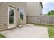 Cozy backyard patio with a wooden fence, convenient door access, and a charming potted plant at 529 Dasheill Ln, Atlanta, GA 30349