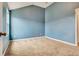 A bedroom with neutral colored carpet, a window, and freshly painted blue walls at 529 Dasheill Ln, Atlanta, GA 30349