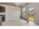 The light filled dining space features new floors, modern lighting and an exit to the backyard at 529 Dasheill Ln, Atlanta, GA 30349