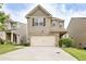 Charming two-story home featuring stone accents, a two-car garage, and a well-maintained front yard at 529 Dasheill Ln, Atlanta, GA 30349
