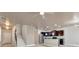 Spacious open-concept living area with stairs, stainless steel appliances, and modern lighting fixtures at 529 Dasheill Ln, Atlanta, GA 30349