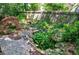 Lush backyard featuring a charming rock garden with water feature and stone pathway at 2866 Wynford Sw Dr, Marietta, GA 30064