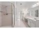 Well-lit bathroom with double vanity, glass shower, and tile flooring at 2866 Wynford Sw Dr, Marietta, GA 30064