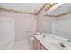 A bathroom features a double sink vanity, decorative wallpaper, and tiled bathtub shower at 2866 Wynford Sw Dr, Marietta, GA 30064