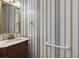 Traditional powder room features a decorative mirror and stylish wallpaper at 2866 Wynford Sw Dr, Marietta, GA 30064