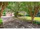 Charming exterior view of home with brick accents, mature trees, and spacious driveway at 2866 Wynford Sw Dr, Marietta, GA 30064