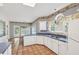 Open kitchen boasts white cabinets, blue countertops, tile floors and lots of natural light at 2866 Wynford Sw Dr, Marietta, GA 30064