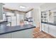 Bright kitchen featuring white cabinets, tile floor and stainless steel sink at 2866 Wynford Sw Dr, Marietta, GA 30064