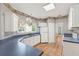Eat-in kitchen featuring white cabinets, blue countertops, and plenty of natural light from the window at 2866 Wynford Sw Dr, Marietta, GA 30064