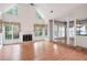 Bright living room featuring a fireplace, large windows with decorative curtains, and hardwood floors at 2866 Wynford Sw Dr, Marietta, GA 30064